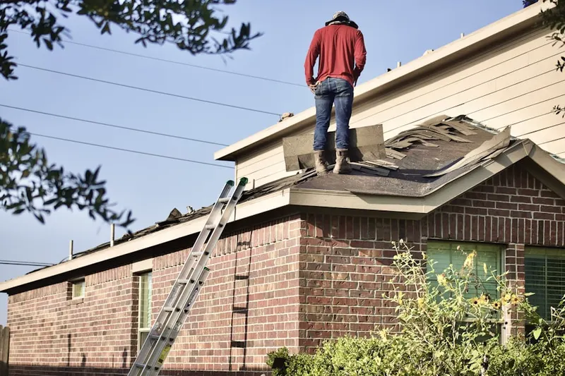 Professional roofer working on a residential roof in Towson